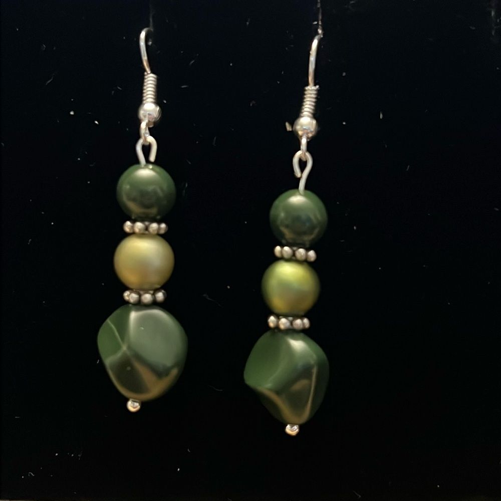 Handcrafted silver tone earrings with green beading.